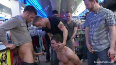 Horny men take down a cocky hustler at a busy sex arcade